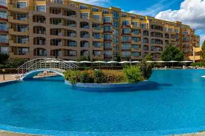 a large swimming pool in front of a large building at Menada Grand Resort Apartments in Aheloy