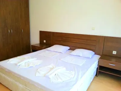 a bed with white sheets and white towels on it at Eden - Menada Apartments in Sunny Beach