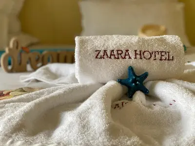 a towel with the word zaria hotel on it at Hotel Zaara in Sunny Beach
