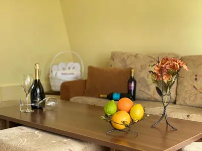 a living room with a coffee table with fruit on it at Hotel Zaara in Sunny Beach