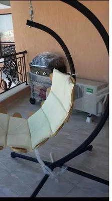 a chair with a pillow in a living room at Amazing apartment facing the sea in Burgas City