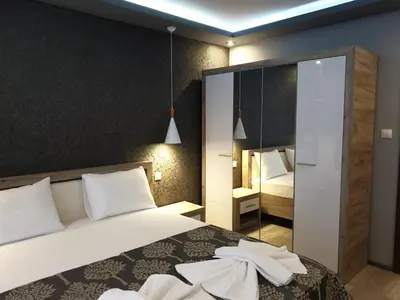a bedroom with a bed with white pillows at MitProt Panorama Bay 2 luks apartment 102 in Sveti Vlas