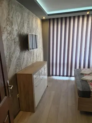 a room with a bed and a tv on a wall at MitProt Panorama Bay 2 luks apartment 102 in Sveti Vlas