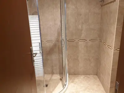 a shower with a glass door in a bathroom at MitProt Panorama Bay 2 luks apartment 102 in Sveti Vlas