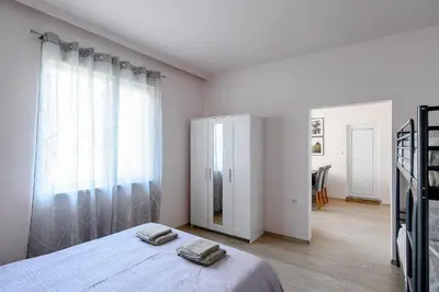 a bedroom with a bed and a large window at Studio Thermi 1 in Varna City