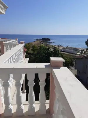 a white balcony with a view of the ocean at Perla Del Mar Aparthotel in Lozenets