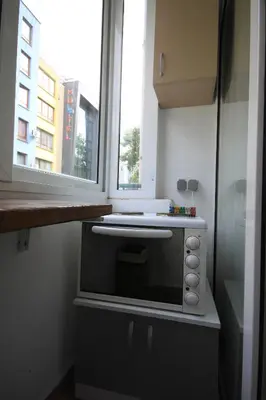 a microwave oven in a kitchen with a window at Studios near to Burgas Free University in Burgas City