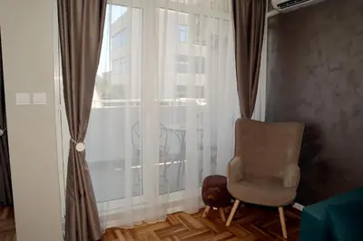 a chair sitting in front of a window at Studios near to Burgas Free University in Burgas City