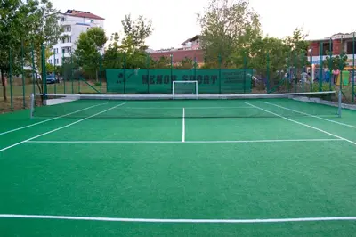 a tennis court with a net on top of it at Belitsa Hotel in Primorsko