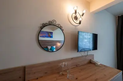a room with a mirror and a wooden table at Belitsa Hotel in Primorsko