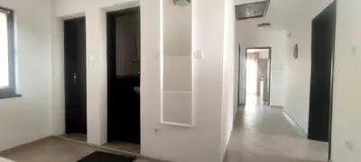 a room with white walls and a hallway with black doors at Yanevi Apartments in Chernomorets
