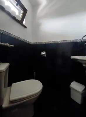 a black bathroom with a toilet and a sink at Yanevi Apartments in Chernomorets