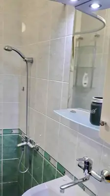 a bathroom with a mirror and a sink and a shower at 500 steps to the sand in Varna City