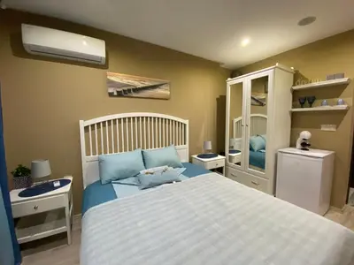 a bedroom with a bed and a sink and a bed sidx sidx sidx at PARADISO 308-309 Private Studios Nessebar in Nesebar