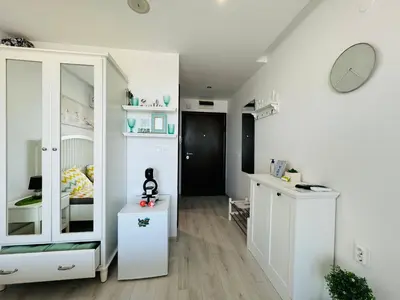 a room with a white cabinet and a bedroom at PARADISO 308-309 Private Studios Nessebar in Nesebar