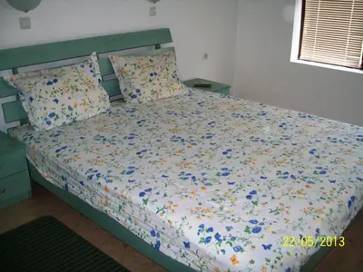 a bedroom with a bed with flowers on it at Apartment in Kambani 1 Apartcomplex in Sveti Vlas