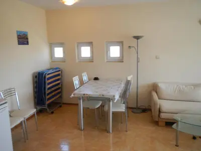 a living room with a table and chairs and a couch at Apartment in Elit 3 Apartcomplex in Sunny Beach