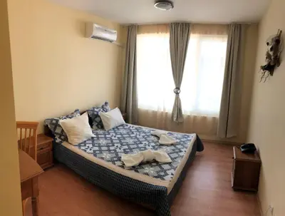 a bedroom with a bed and a window at Family Hotel Littoral in Sozopol