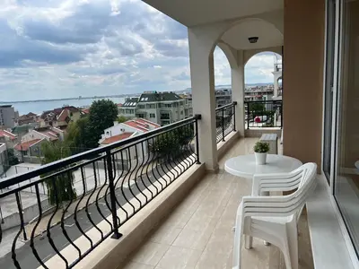 a balcony with a table and chairs and a view at Antorini Apartments in Sveti Vlas