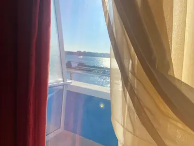 an open window with a view of the ocean at Ribarska Sreshta Family Hotel in Tsarevo