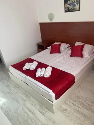 a bedroom with a bed with four towels on it at Ribarska Sreshta Family Hotel in Tsarevo