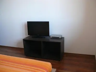 a television sitting on a stand with a keyboard at Complex Kentavar - Free Fast WiFi in Sveti Vlas