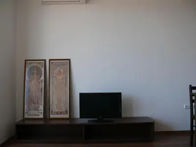 a room with a tv and two posters on a wall at Complex Kentavar - Free Fast WiFi in Sveti Vlas