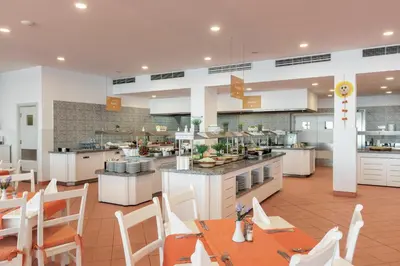 a large kitchen and dining room with tables and chairs at AluaSun Helios Beach - All Inclusive in Obzor