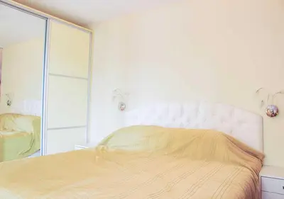 a bedroom with a large bed and a mirror at Dom-El Real Apartments 4 - Sveti Vlas in Sveti Vlas
