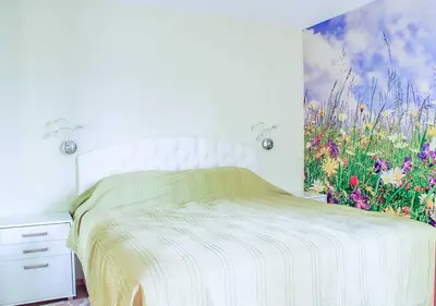 a bedroom with a bed with a painting on the wall at Dom-El Real Apartments 4 - Sveti Vlas in Sveti Vlas