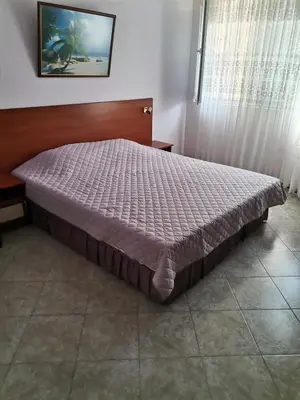 a large bed in a bedroom with at Guest House Konomaevi in Sozopol