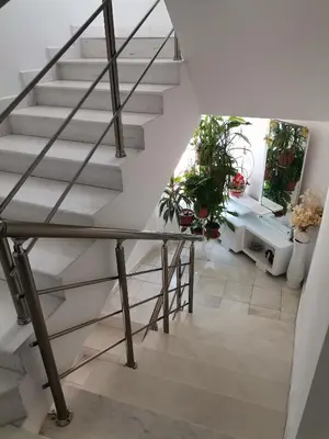 a staircase in a house with potted plants at Guest House Konomaevi in Sozopol