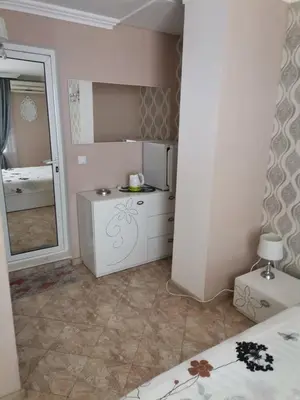 a small bathroom with a mirror and a sink at Guest House Konomaevi in Sozopol