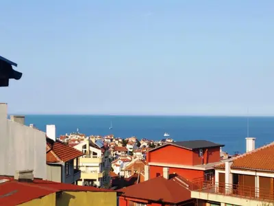 a view of a city with the ocean in the background at Guest House Konomaevi in Sozopol