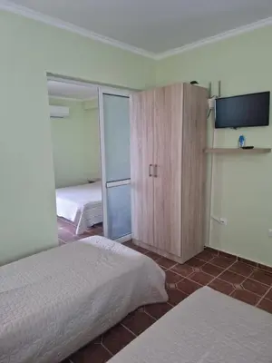 a bedroom with two beds and a sliding glass door at Dara Hotel in Primorsko