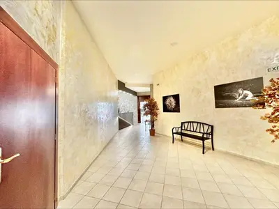 a hallway with a bench in a building at Menada Miramar Palace Apartments in Sunny Beach