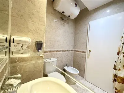 a bathroom with a toilet and a sink at Menada Miramar Palace Apartments in Sunny Beach