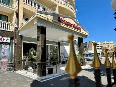 a restaurant with a sign on the front of a building at Menada Miramar Palace Apartments in Sunny Beach