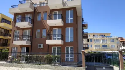an apartment building with balconies on a street at Complex Argo in Ravda