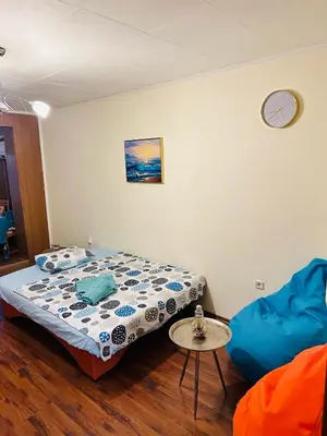 a bedroom with a bed and a table and a chair at Colorful 1-BDR Apartment - Top center of Burgas by Flаt Manаger in Burgas City