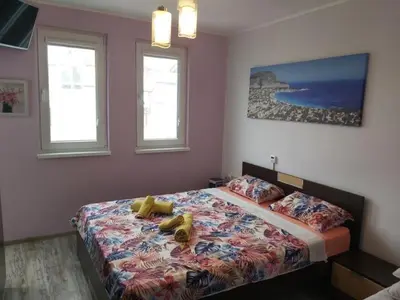 a bedroom with a bed in a room with windows at Colorful 1-BDR Apartment - Top center of Burgas by Flаt Manаger in Burgas City