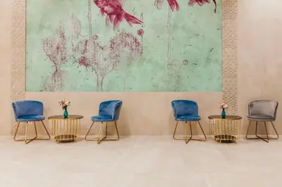a room with four chairs and a painting on the wall at Marina Burgas Hotel in Burgas City