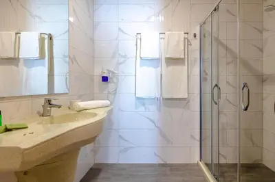 a bathroom with a sink and a shower at Marina Burgas Hotel in Burgas City
