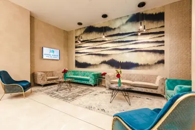 a living room with couches and a painting on the wall at Marina Burgas Hotel in Burgas City