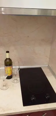 a counter with two glasses and a bottle of wine at Aphrodite Rose in Sunny Beach