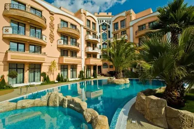 a swimming pool in front of a building at Aphrodite Rose in Sunny Beach