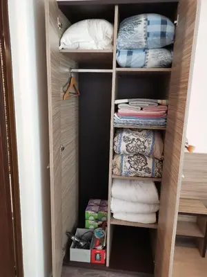 a walk in closet with towels and pillows at Clara Sea View in Burgas City