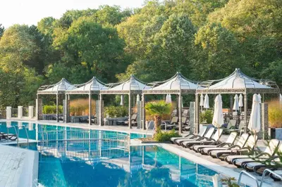 a swimming pool with chairs and a gazebo at Marina White Sands Beach Hotel-All Inclusive in Obzor