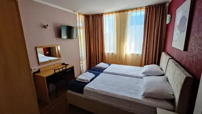 a hotel room with a bed and a mirror at Favorit Aparthotel in Sunny Beach