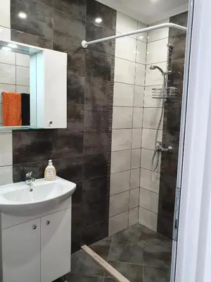 a bathroom with a shower and a sink at Апартамент Катлена in Pomorie
